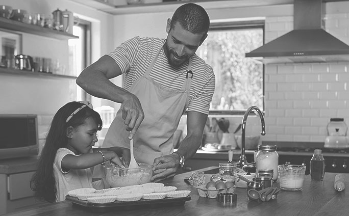 Cropped shot of a young man baking at home with his young daughter